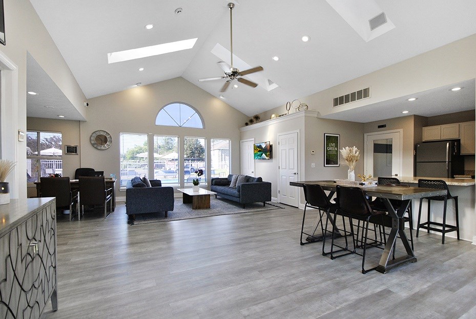 A modern open-concept living room with a dining area and kitchen.