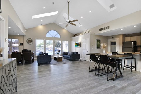 A modern open-concept living room with a dining area and kitchen.