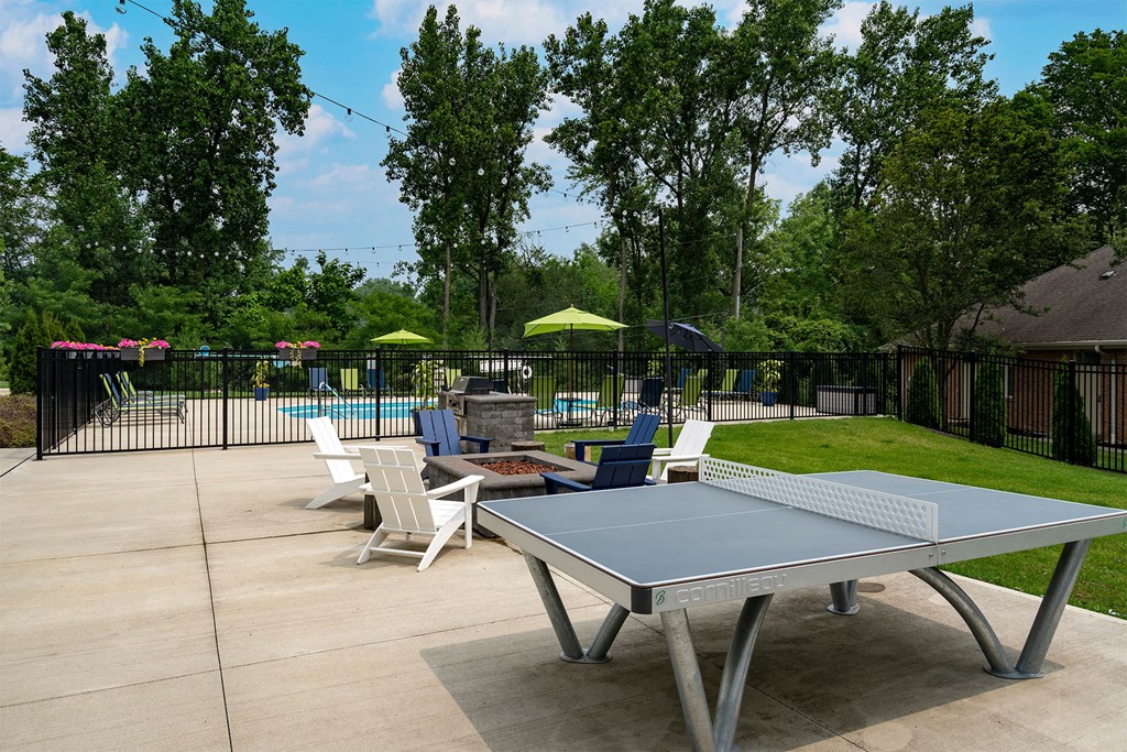 a ping pong table on a patio next to a pool