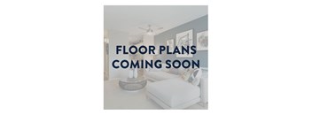 A living room with a white sofa and a coffee table, and a ceiling fan.
