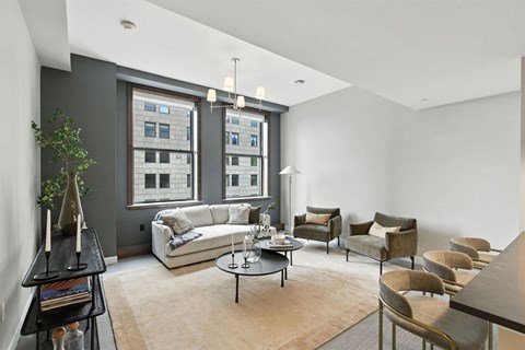 A living room with a white couch and a large window.