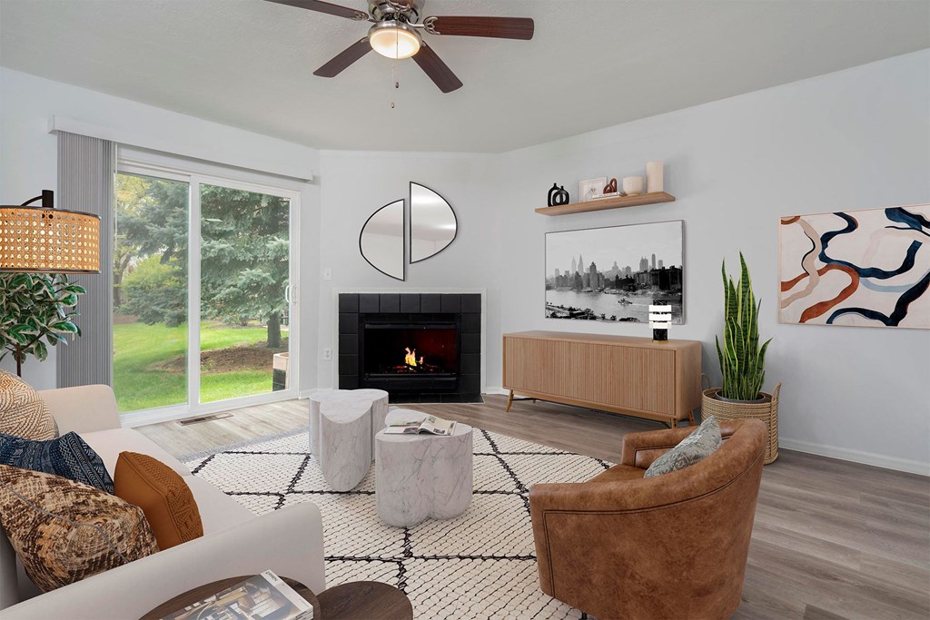 a living room with a couch and chairs and a fireplace