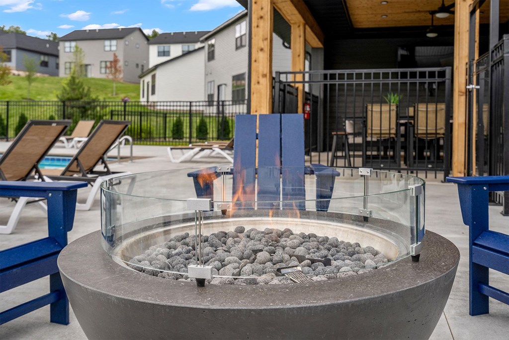 a fire pit with rocks in the middle of a patio