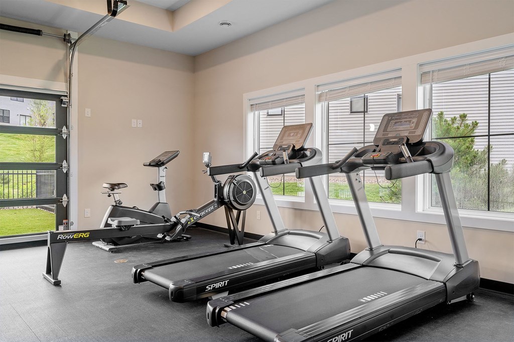 two treadmills and two elliptical machines in the fitness room