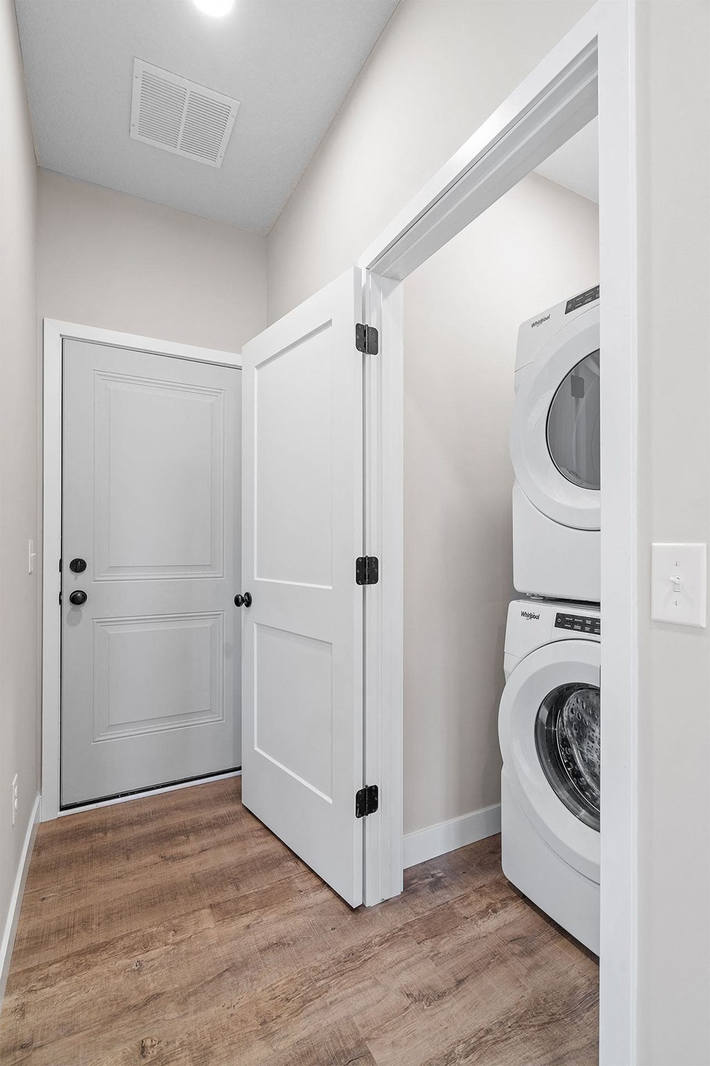 a laundry room with white doors and a washer and dryer