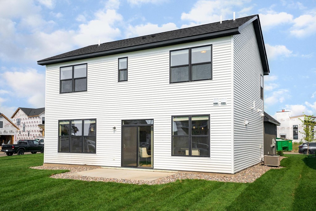 a home with white siding and a black roof