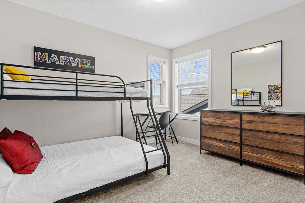 a bedroom with a bunk bed and a dresser