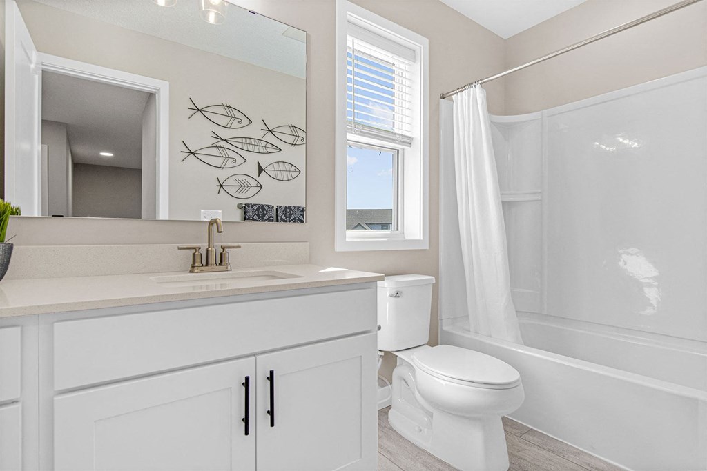 a bathroom with a toilet sink and bathtub