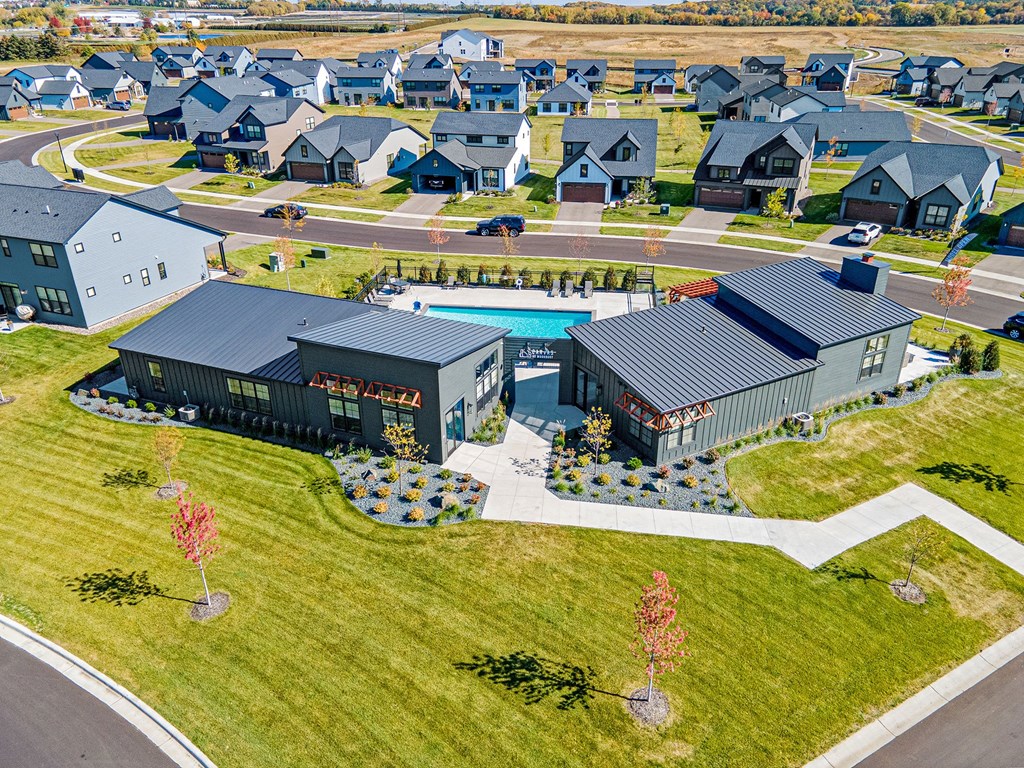 an aerial view of a house with a swimming pool in the yard