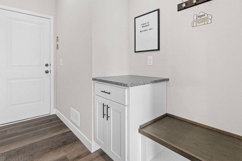 a utility room with a counter and bench in a 555 waverly unit