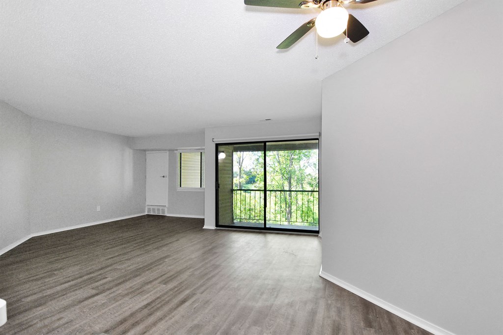 updated living room with a ceiling fan and a window