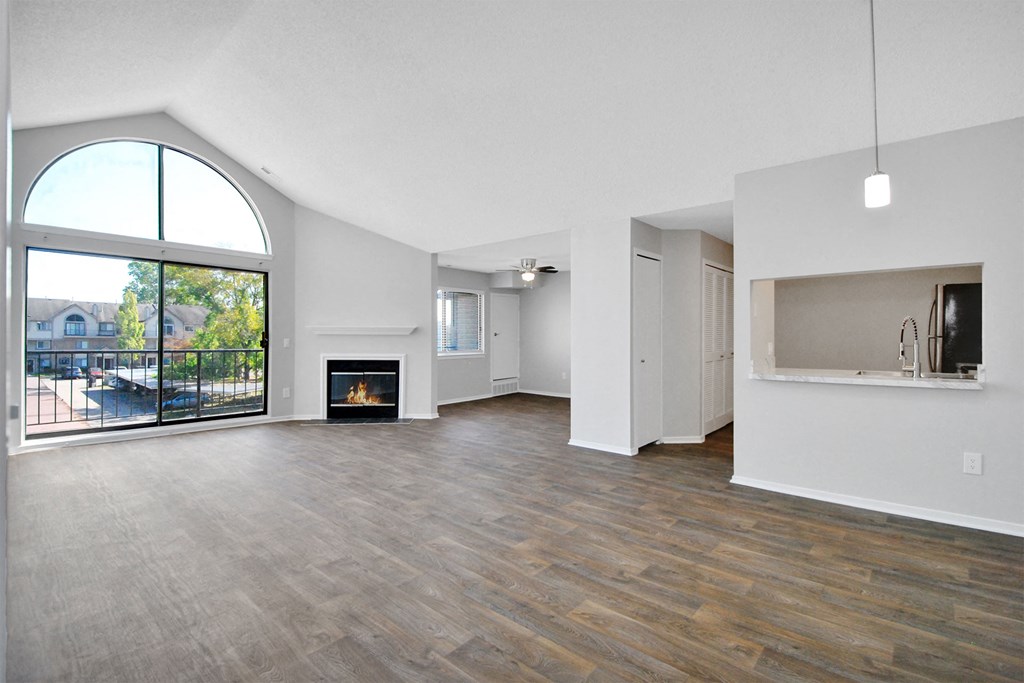 spacious living room with a fireplace and a large window