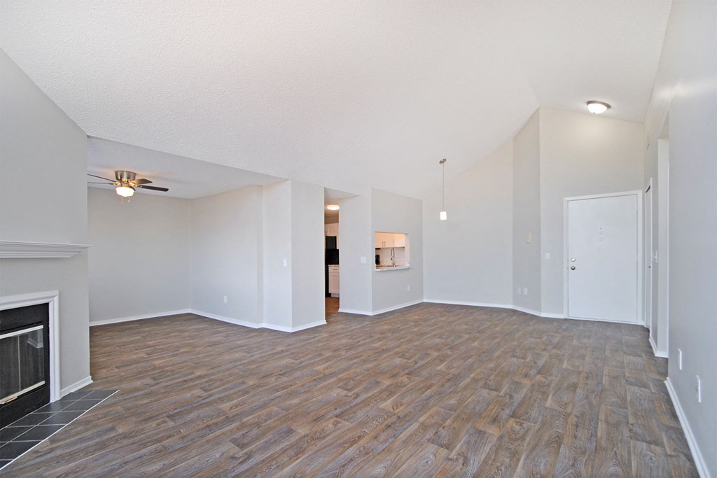 a living room with a fireplace and wood flooring