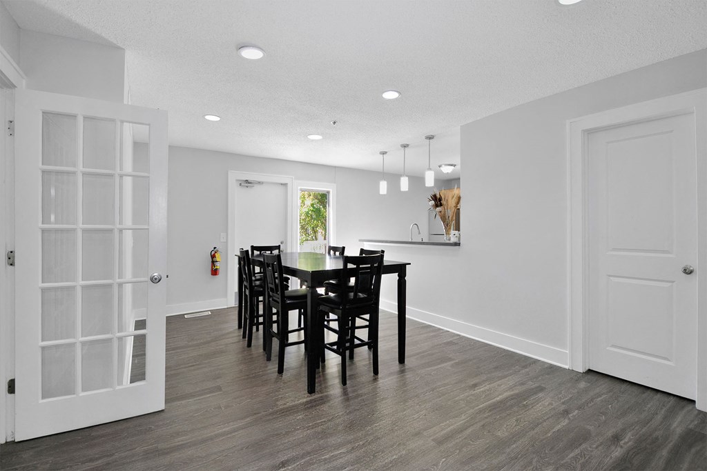 a dining room and kitchen with a table and chairs