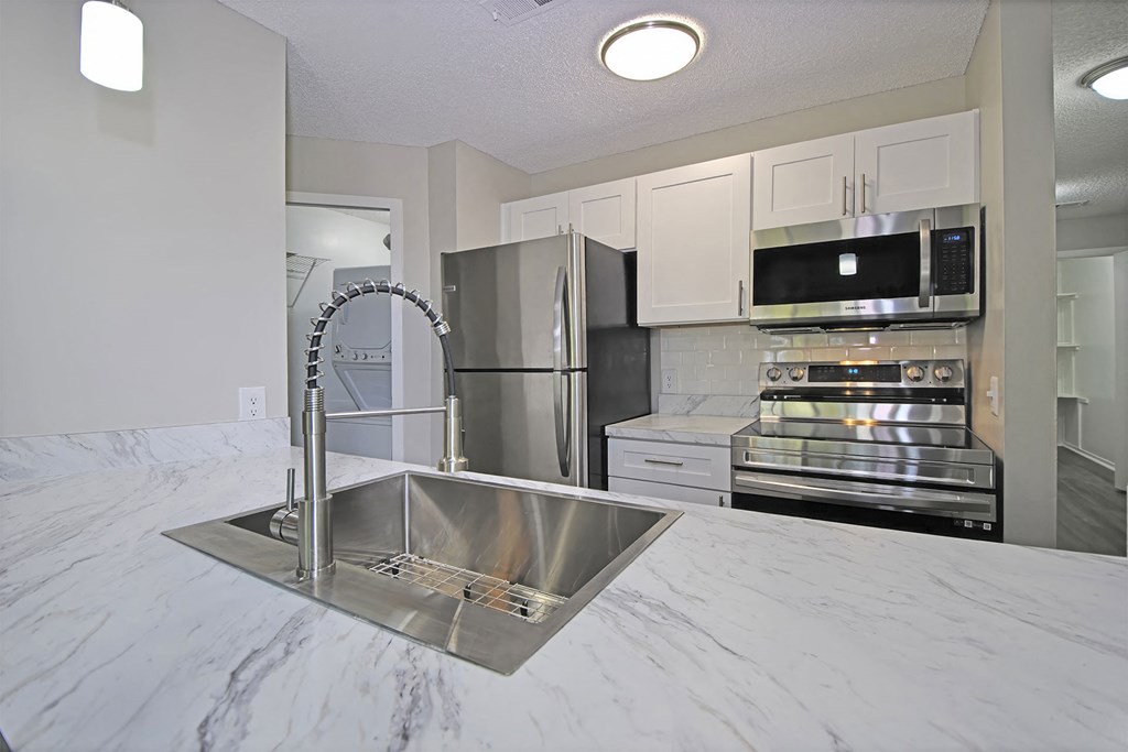 a kitchen with a sink and a refrigerator