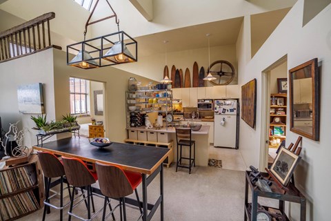 A kitchen with a table and chairs in the middle of the room.