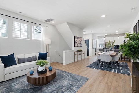 A modern living room with a white sofa and a coffee table.