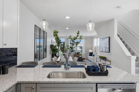 A modern kitchen with a large island and a stainless steel sink.