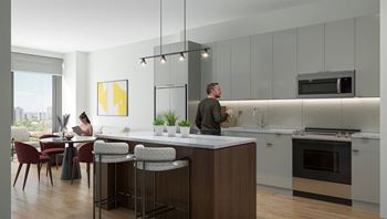 a man standing in a kitchen with a counter top