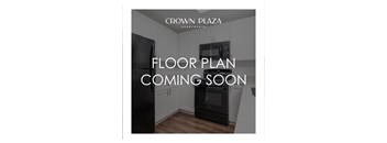 A kitchen interior with a black fridge and microwave, and a message about a floor plan coming soon.