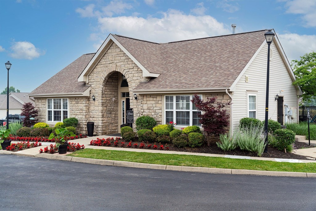 the front of a house with a driveway and landscaping