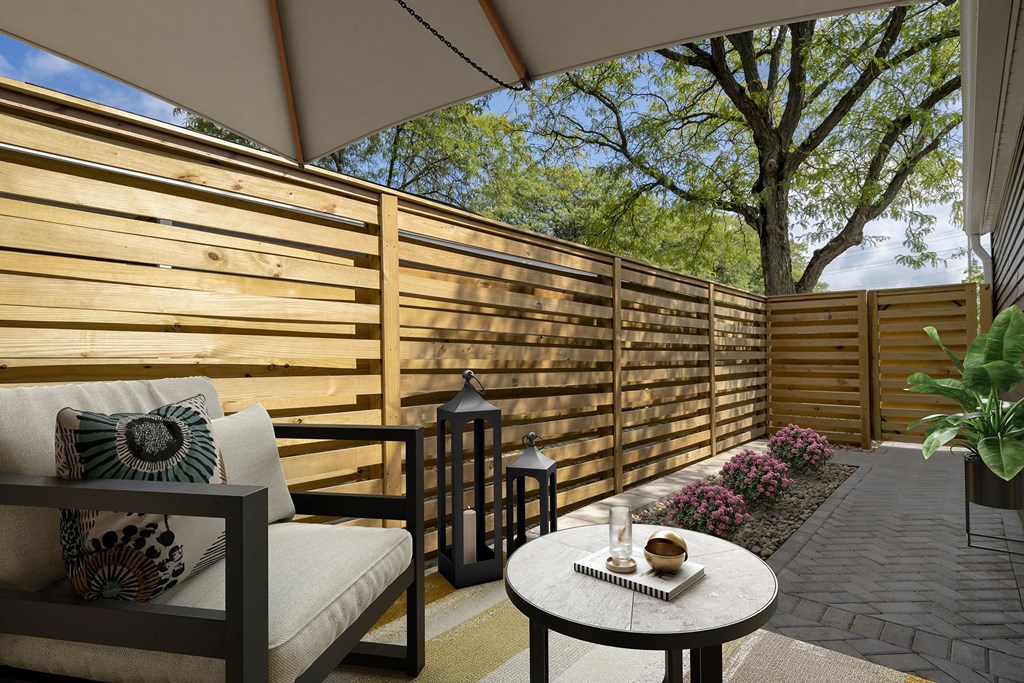 a patio with a wooden privacy fence