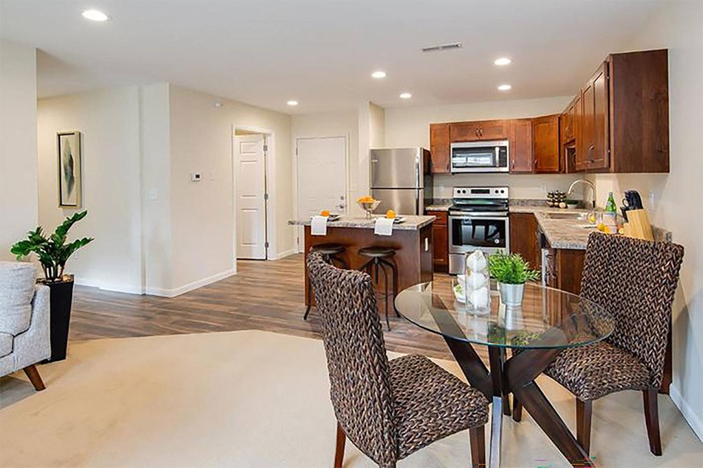 a kitchen and dining room with a table and chairs