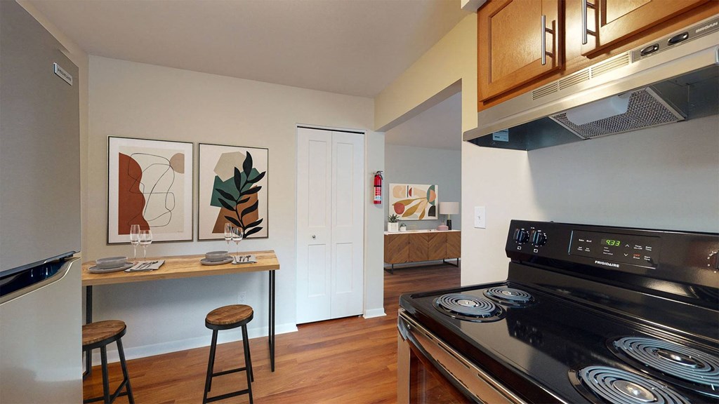 a kitchen with a stove and a counter with stools