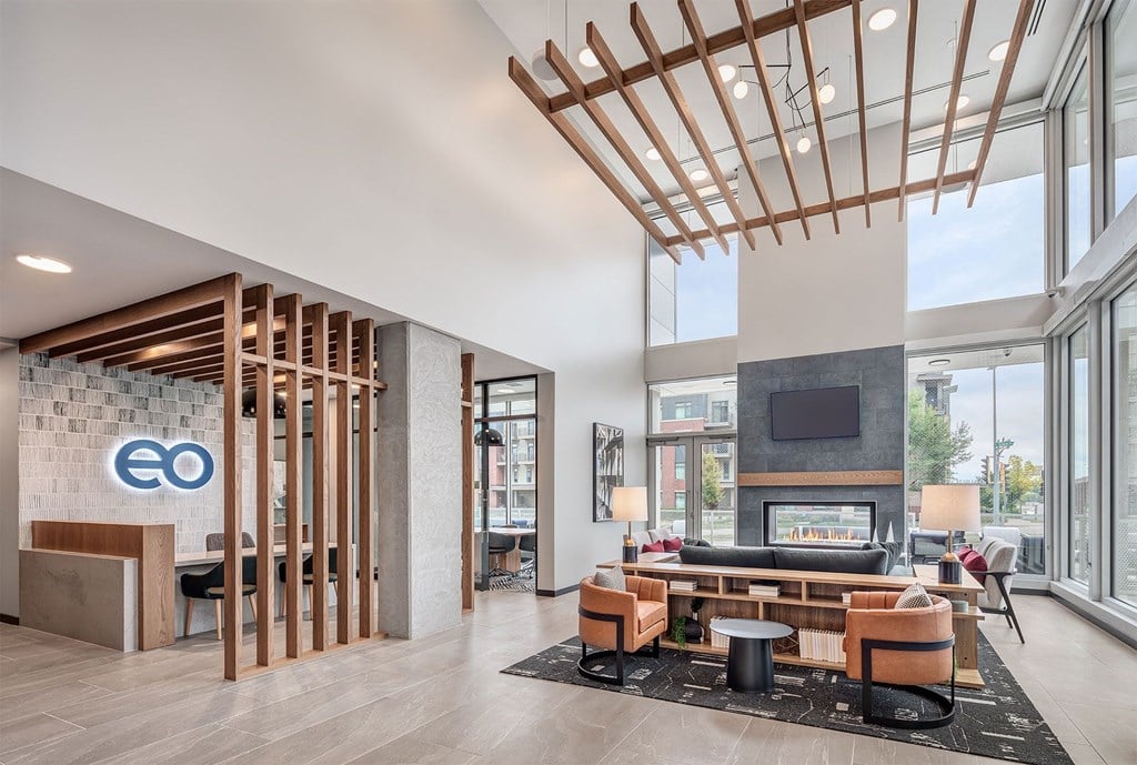 the lobby of a hotel with a couch and a fireplace