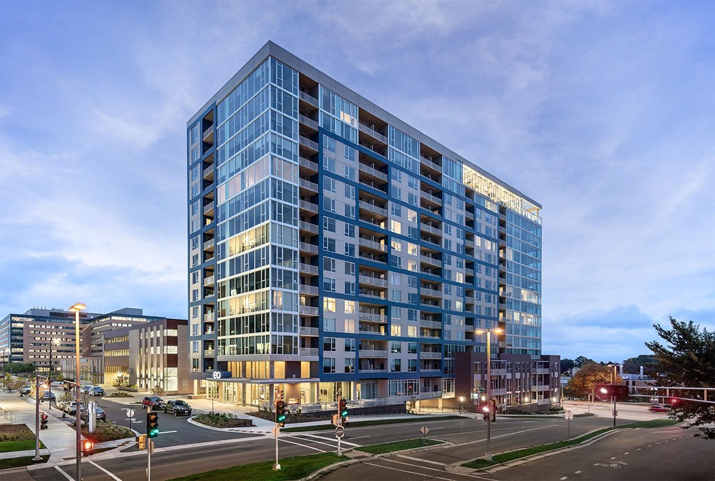 an apartment building on a city street at dusk