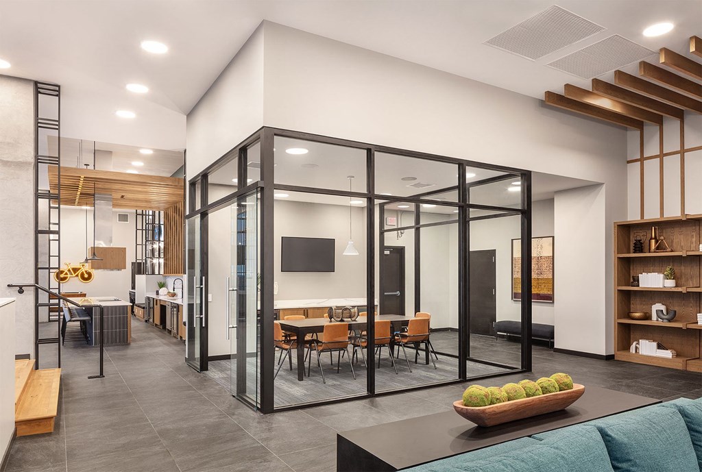 a conference room with glass walls and a table and chairs