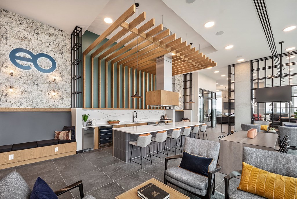 a clubhouse with a bar and chairs and a lobby with a table and chairs