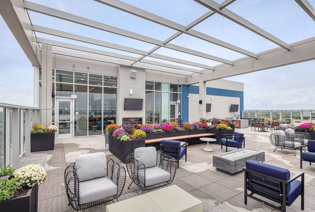 a terrace with chairs and tables and a large glass roof