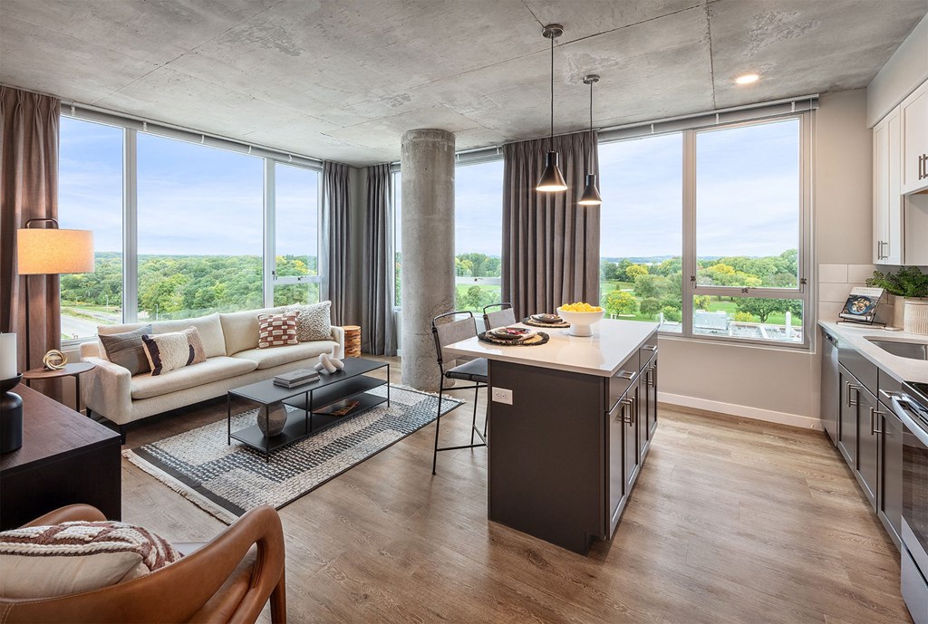 a living room and kitchen with a view of the city