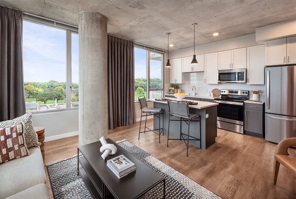 a living room with a kitchen and a dining room