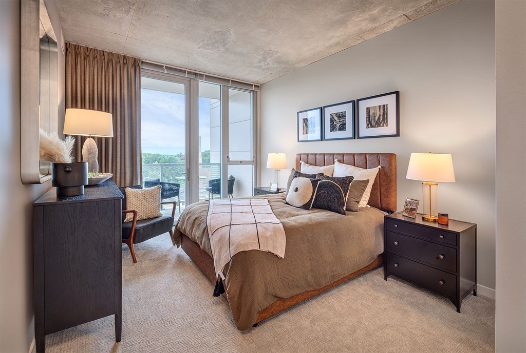 a bedroom with a bed and a large window