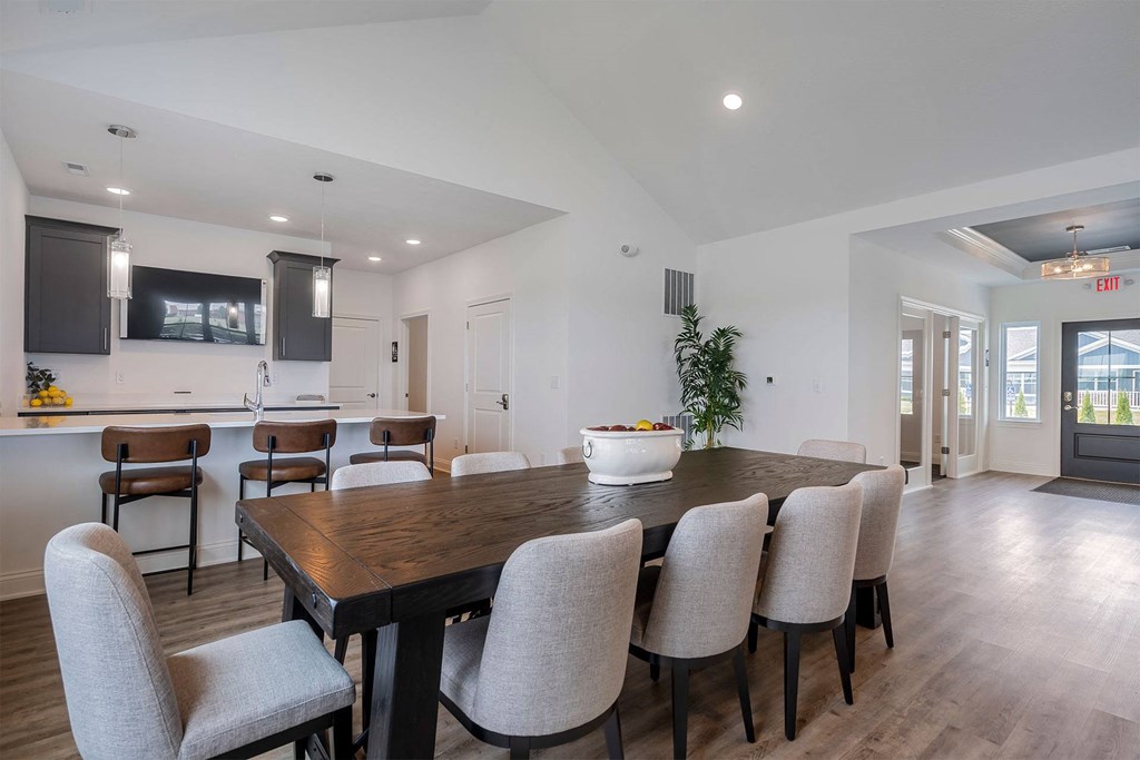 a dining area with a table and chairs