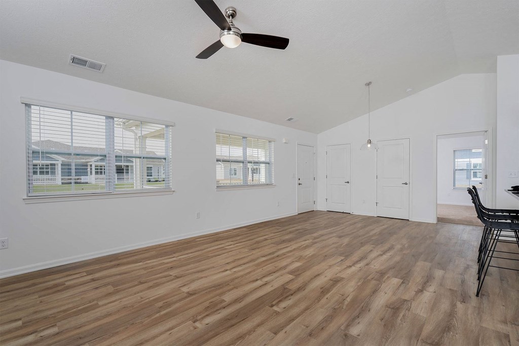 a living room with hardwood floors and white walls
