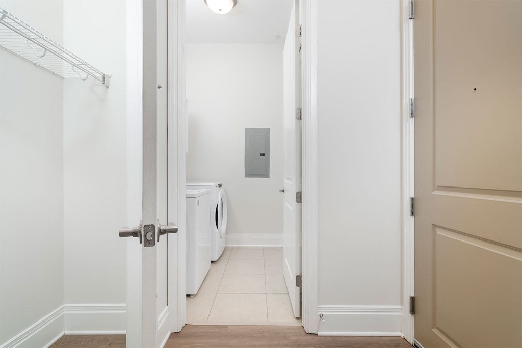 a laundry room with a washer and dryer in a 555 waverly unit