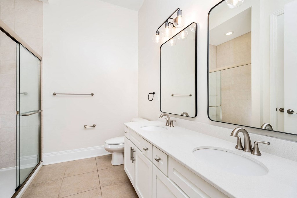 a bathroom with two sinks and a toilet