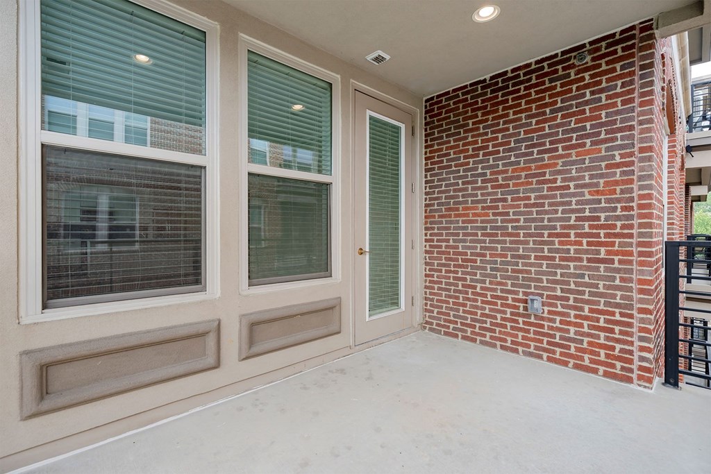 a covered patio with a brick wall