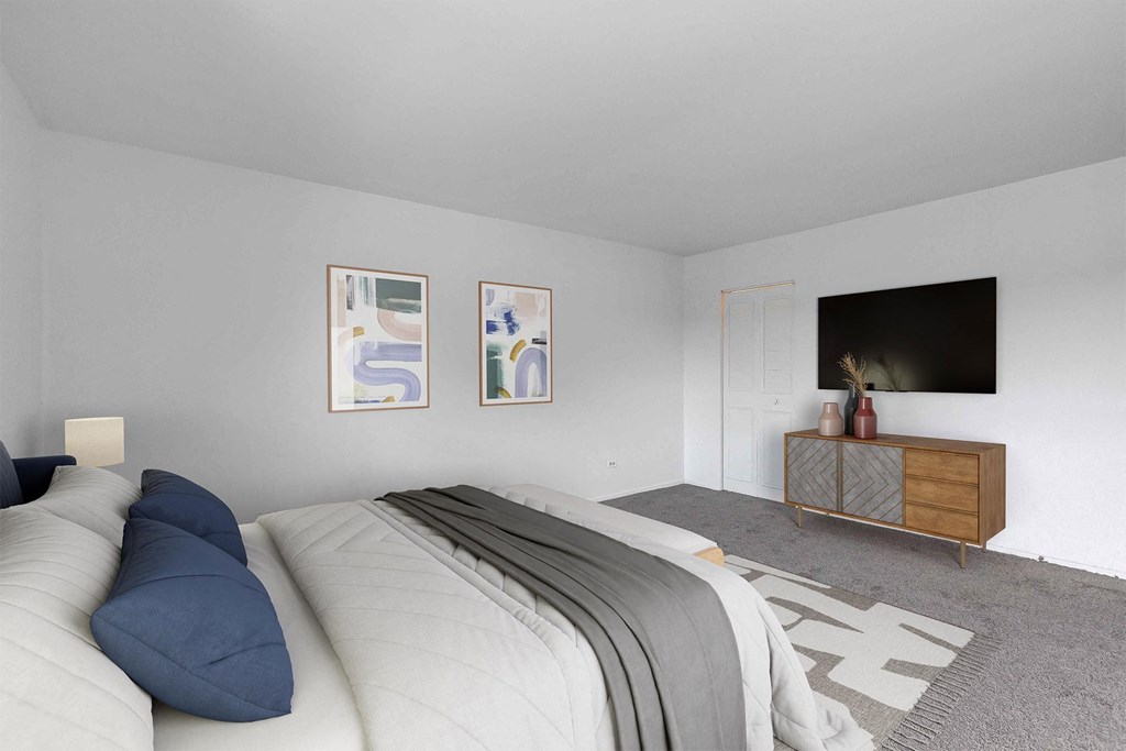 a bedroom with a large bed and a tv on the wall