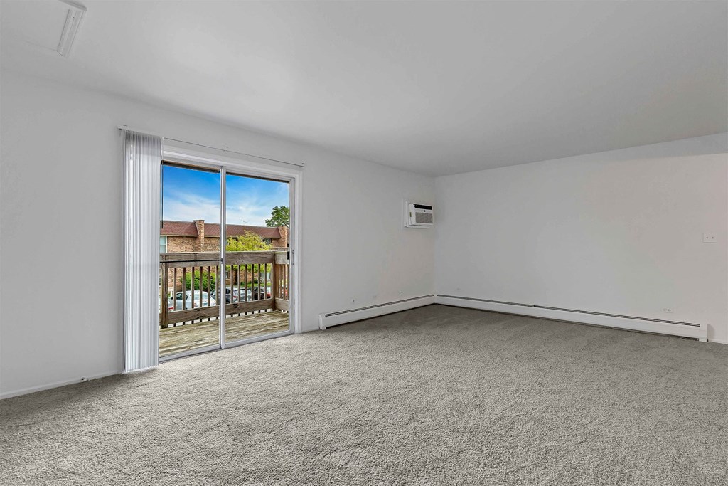 a bedroom with a sliding glass door and a balcony