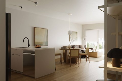 A modern kitchen with a dining table and chairs.