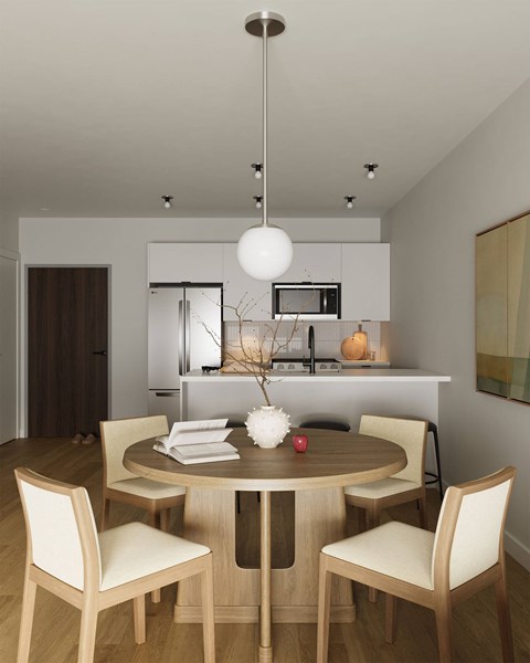 A modern dining room with a round table and chairs.
