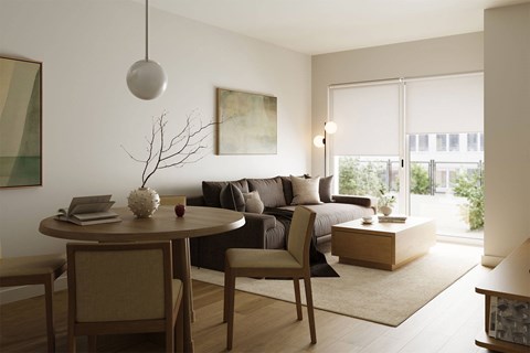 A modern living room with a round table and chairs.