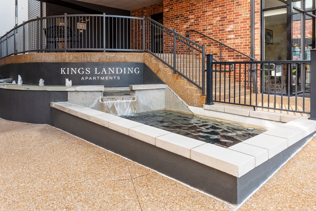the fountain in front of the kings landing apartments building