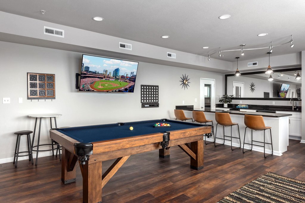 a game room with a pool table and a tv