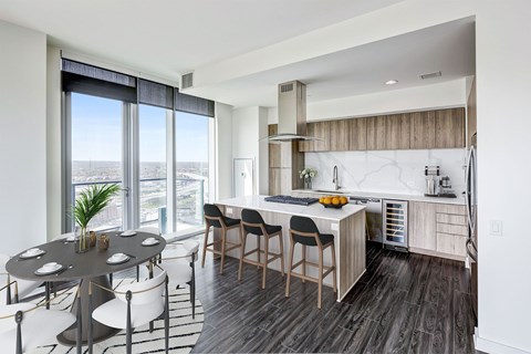 A modern kitchen with a dining table and chairs.