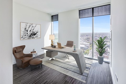 A modern living room with a brown chair and a grey sofa.